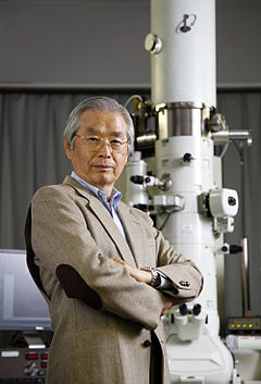 Sumio Iijima with multiple scientific instruments in the background © CC BY-SA
