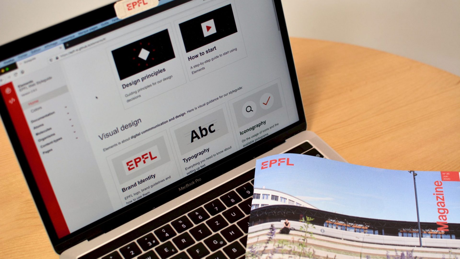 Ordinateur avec un EPFL Magazine possé dessus