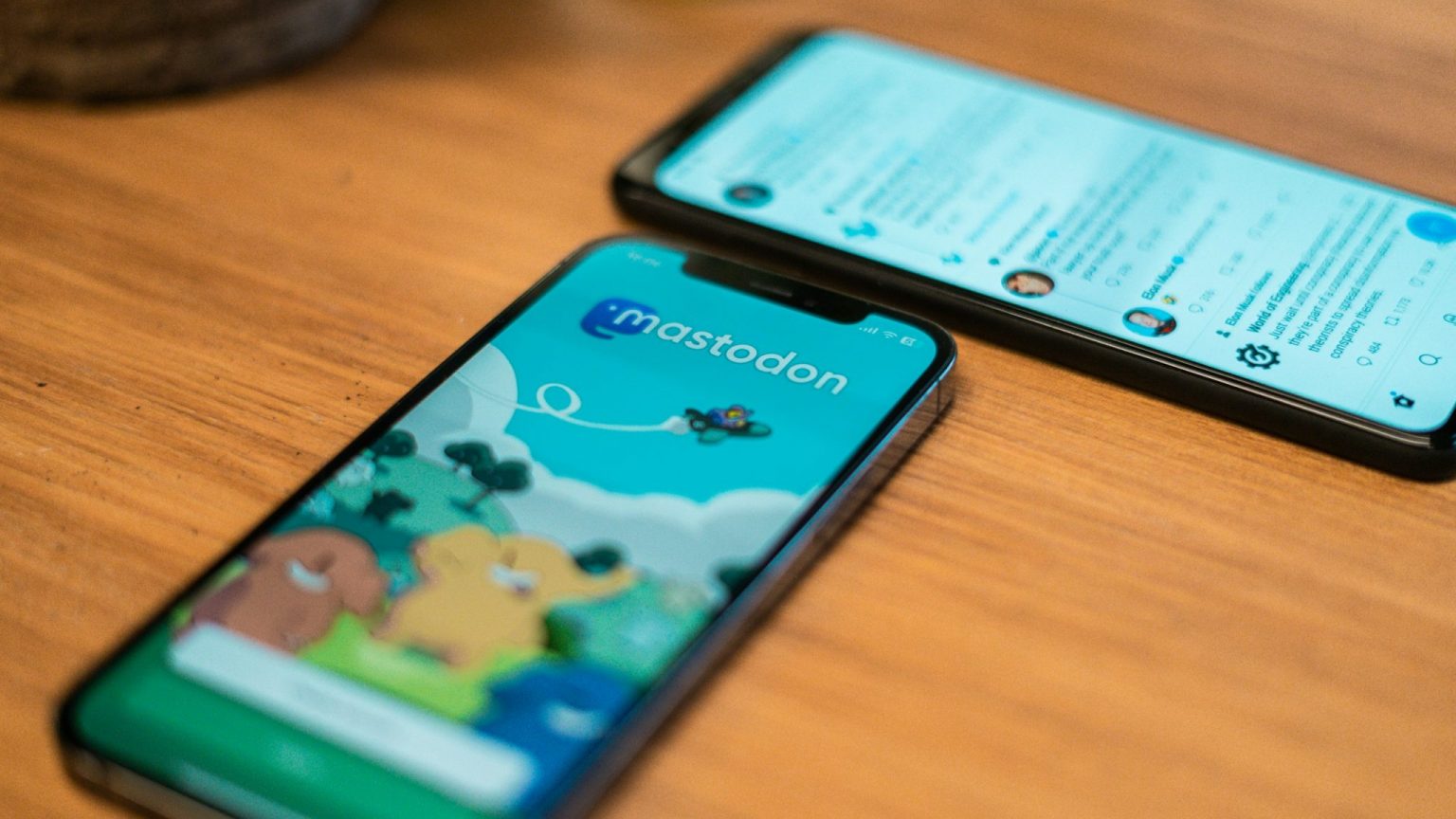 Deux téléphones portables posés sur une table. Sur l'un, une page d'accueil de Mastodon; sur l'autre, un flux Mastodon © Unsplash